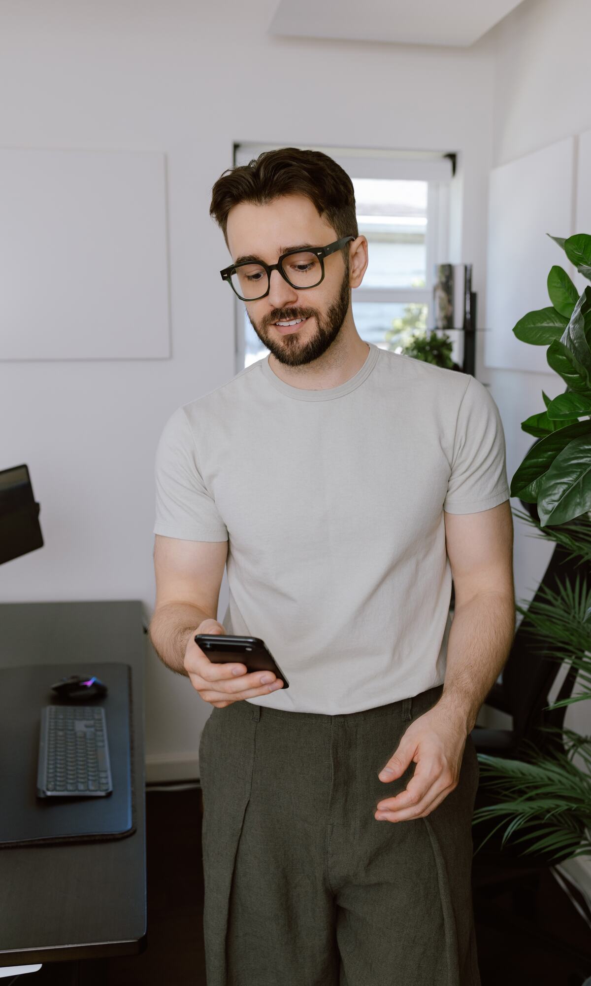 Devlin Peck reading a message on his phone in his office